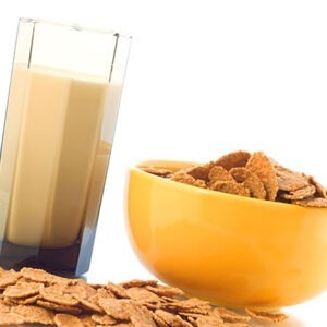 Bowl with corn flakes and milk in the glass for breakfast