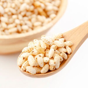 puffed rice on wooden spoon