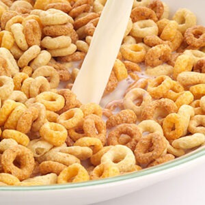 Bowl of breakfast cereal with fresh milk being poured