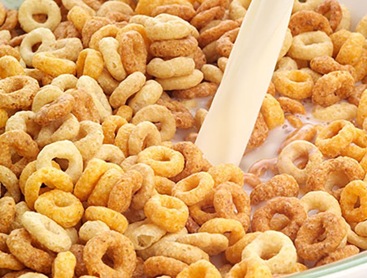 Bowl of breakfast cereal with fresh milk being poured
