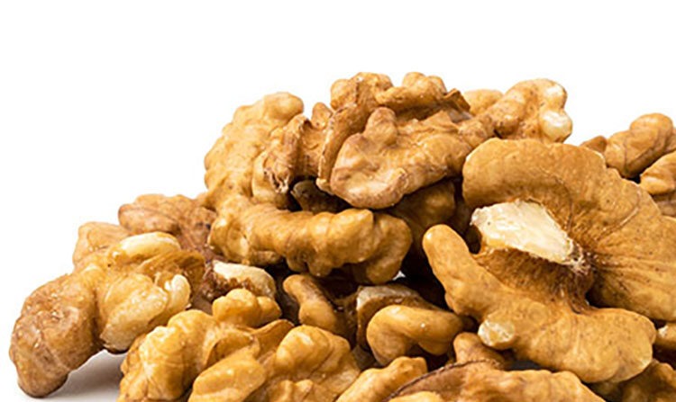 Pile of peeled walnuts, closeup.